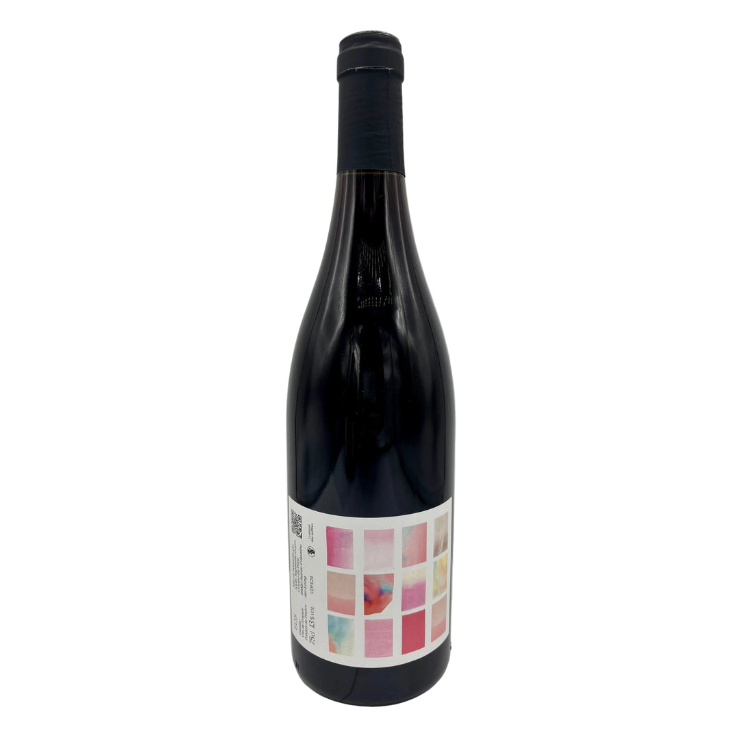 Wine bottle with a colorful label containing pink squares on a white background