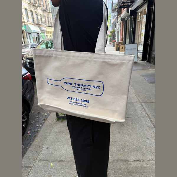 Wine Therapy NYC cream canvas tote bag with blue wine bottle graphic and contact details